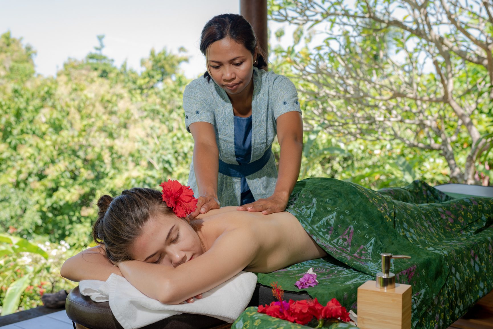 Guest receiving a Balinese massage in a quiet treatment space at Alamanda